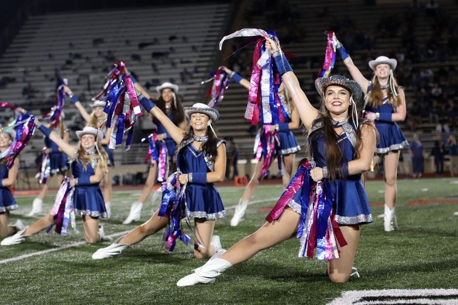 Members of the Silver Stars perform at a football game.