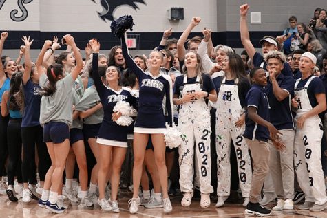 The Navy Empire cheers for the senior class during the pep rally on Friday, November 15th. “We loved being loud and obnoxious,” senior Brooke Forsyth said. The Navy Empire, created to increase school spirit during pep rallies and football games, competed with the other grades to be the loudest and most spirited during the pep rally. 