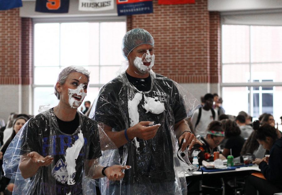 Teachers Andy Easton and Sydney Lynch laugh after getting pied.