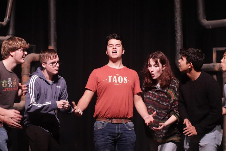 Members of the musical cast act out a scene at rehearsal.