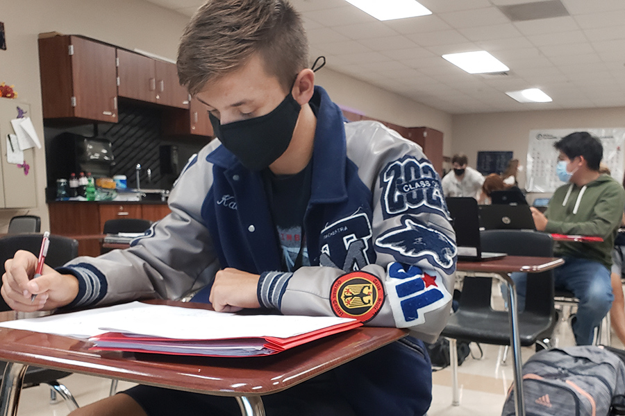 Senior Kaedyn Colton uses Advisory to catch up on his homework. Later, hell join his fifth period in a relaxing game of Among Us.