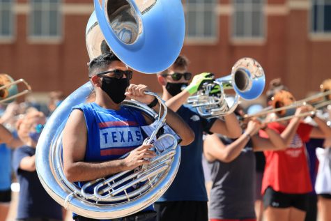 Junior Michael Rodriguez plays the sousaphone at marching band practice after school.