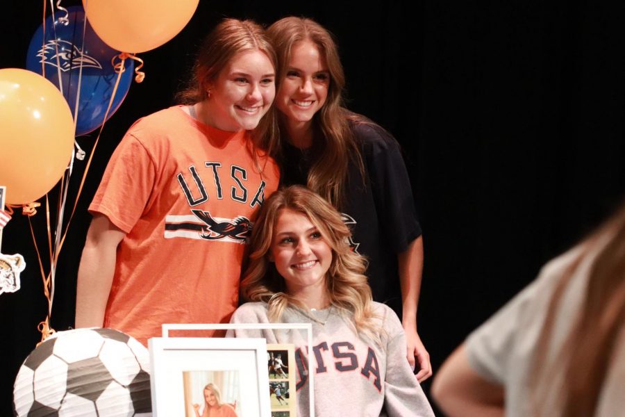 Senior Abigail Wilson poses with family after signing.