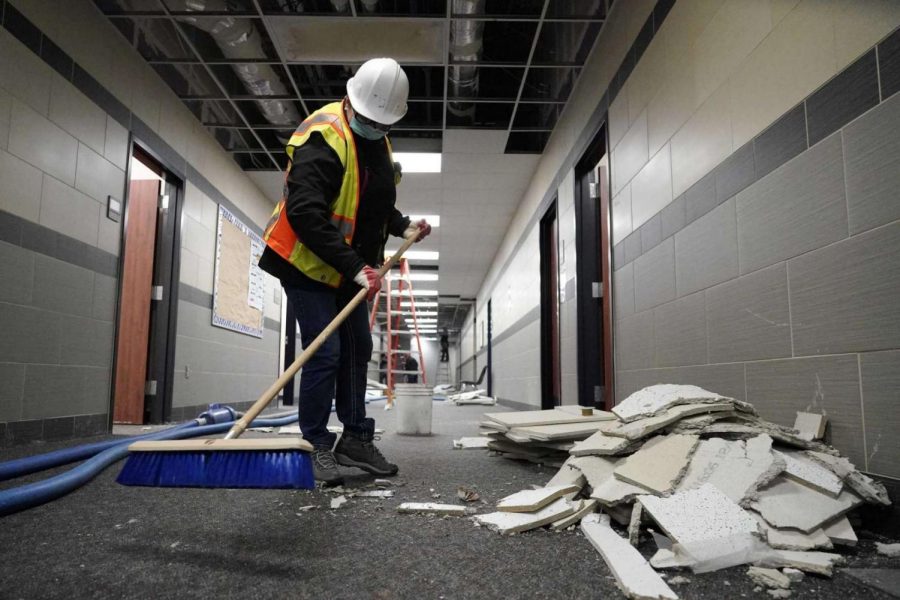 Workers continue cleaning water-related damage throughout the building.