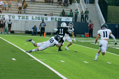 Tyler Torres and Kale Berter attempt to drag down a Spring Wide Receiver before he reaches the end zone
