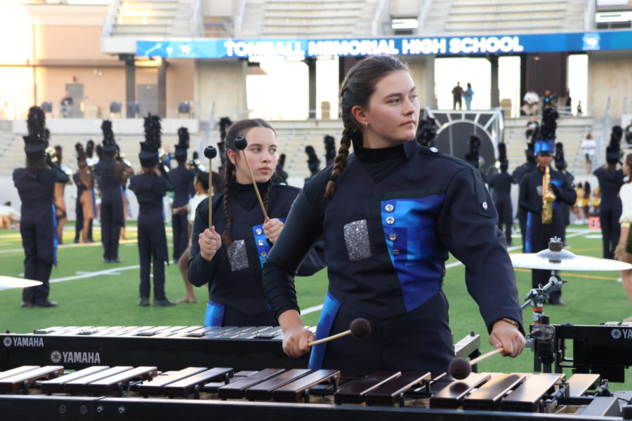 From left to right: Leah Murphy, freshman and Aubrie Austin, freshman playing xylophone at the homecoming game