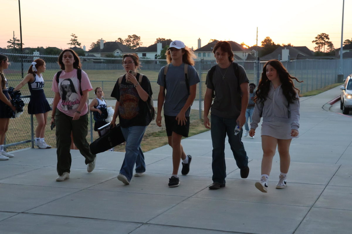 Students walk together as they enter the building on the first day of school.